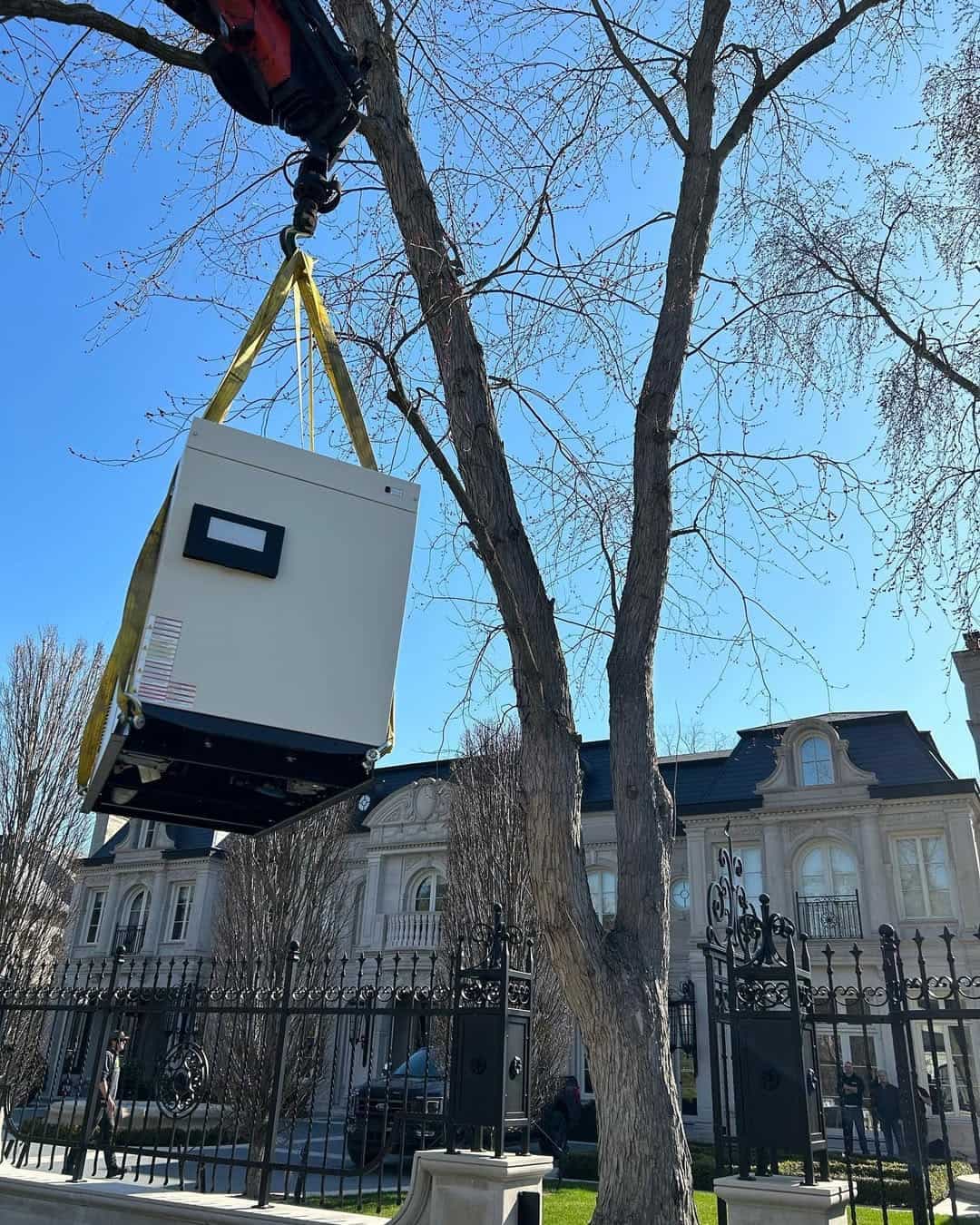 Crane assistance for generator installation at Forest Hill property. Precision placement in tight urban setting