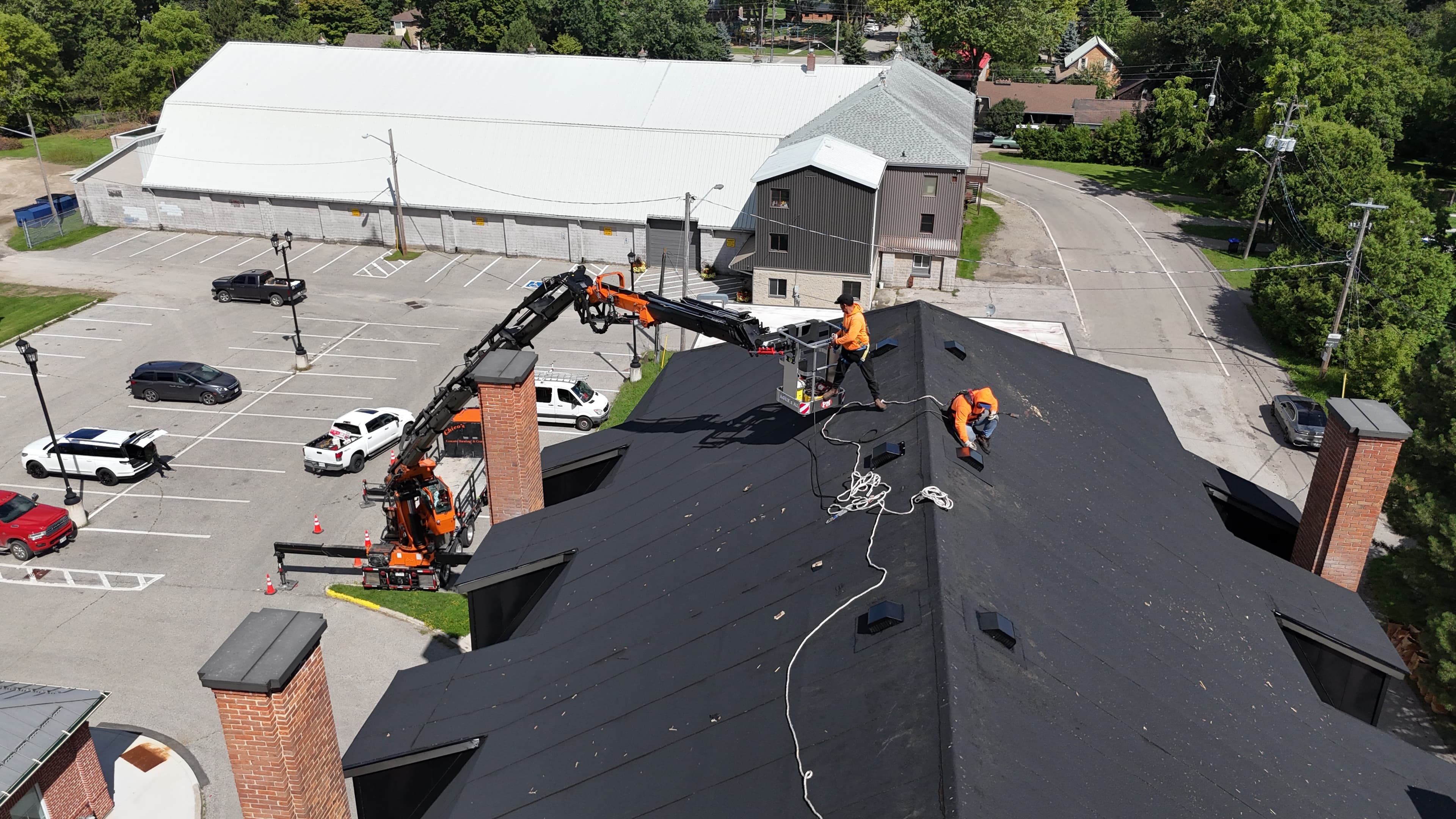 Crane service man basket lift for roofing company in Beeton